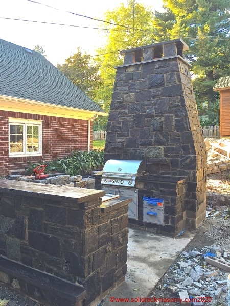 Stone outdoor kitchen and fireplace