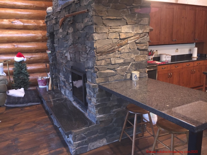 Slate-masonry-heater-with-granite-hearth-and-breakfast-table