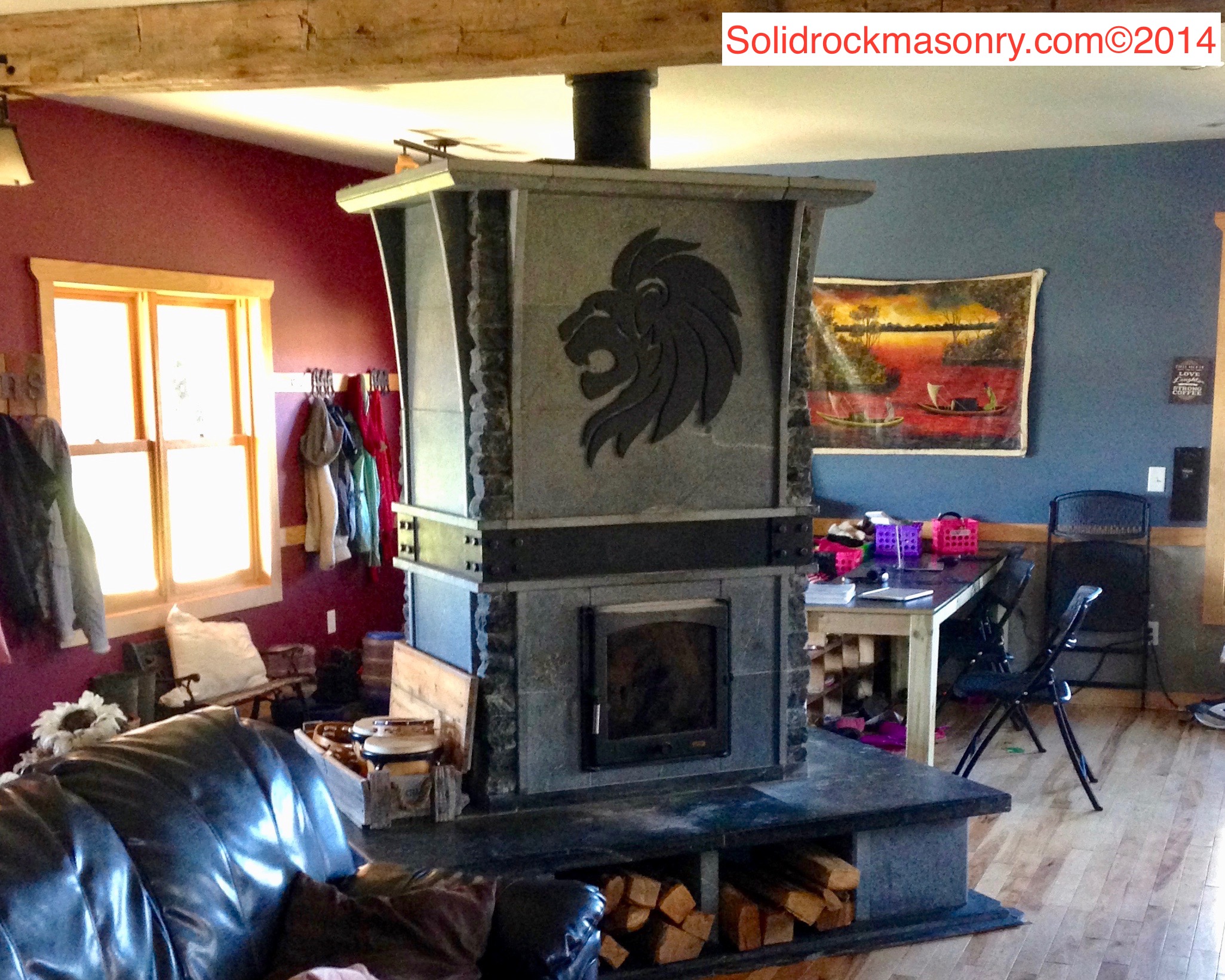 Christensen SR-18 see-thru masonry heater Finished in Custom Alberene Soapstone with a 4 sided bench