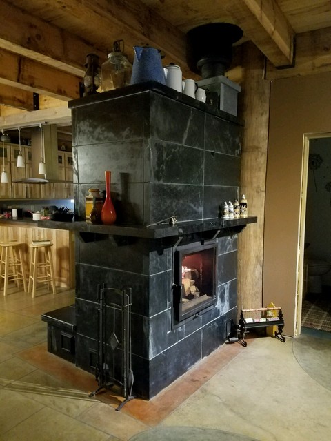 Tietjens SR-22 Bell Masonry Heater with rear white oven.  Custom Soapstone facing, mantle, and heated bench.