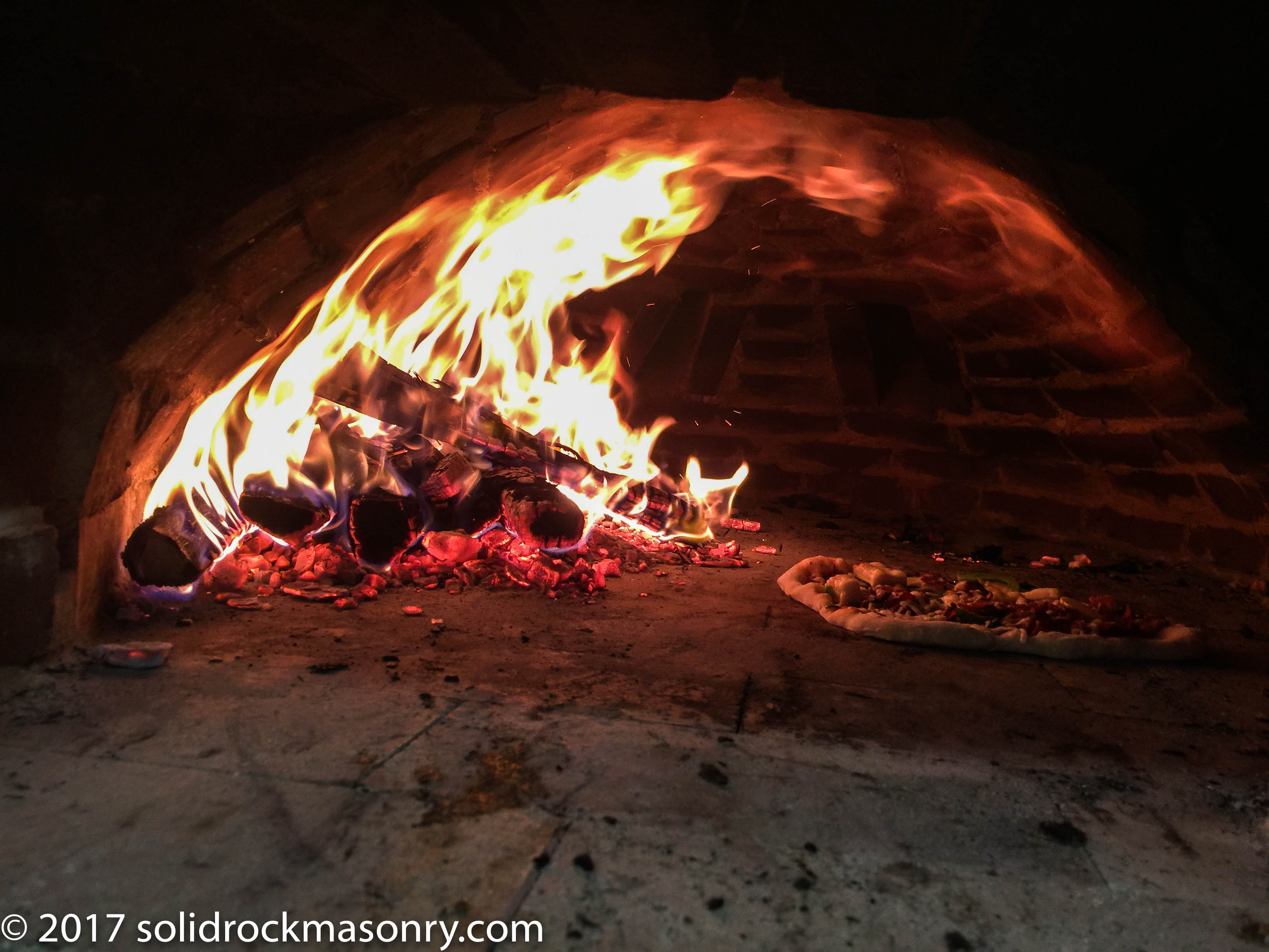 pizza cooking in a new pizza oven