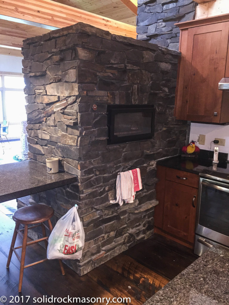 stacked masonry heater in slate and stucco